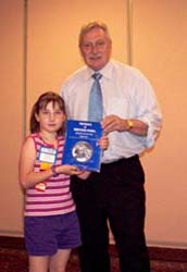 Sabrina Boyer receiving Medals of British India by Robert Puddester from Charles Moore, President of the C.N.A.